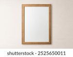 Blank wooden frame, beige wall. flay lay design. Minimal wooden frame. Simple wooden frame. Natural wooden frame.