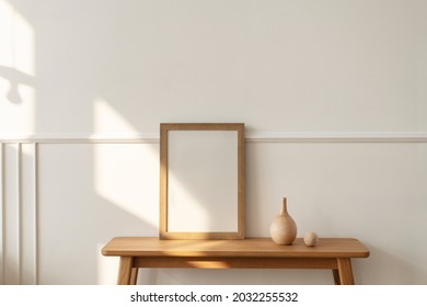 Blank wooden frame on a bench in a modern living room