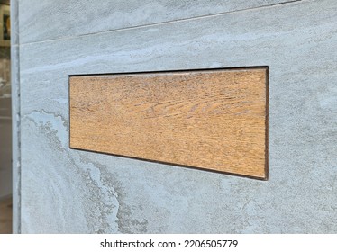 Blank Wooden Plate Sign On Marble Wall For Logo And Text Mockup. Rectangular Signage For Professional Business Company