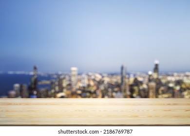 Blank Wooden Table Top With Beautiful Blurry Skyline At Night On Background, Mockup