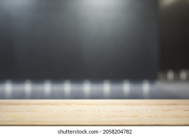 Blank Wooden Tabletop With Empty Space On Modern Shopping Mall Exterior Background At Night, Close Up, Mockup