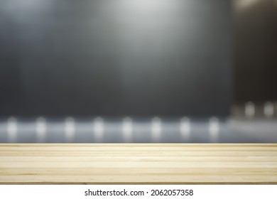 Blank Wooden Tabletop With Empty Space On Modern Shopping Mall Exterior Background At Night, Closeup, Mock Up