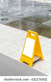 Blank Yellow Hazard Sign Alerts For A Wet Floor In Fountain Decoration Area.