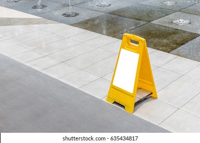 Blank Yellow Hazard Sign Alerts For A Wet Floor In Fountain Decoration Area.