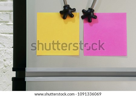 Blank Yellow, Pink Paper Notes Sticked on Refridgerator Door for Add Text Message