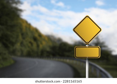 Blank yellow road sign on empty asphalt highway, space for text