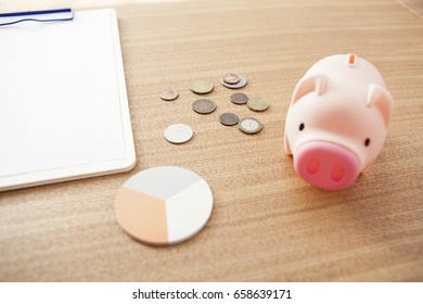 Blank(empty) Clip Board With Pig Coin Bank, Coin, Post It On The Wood Desk.