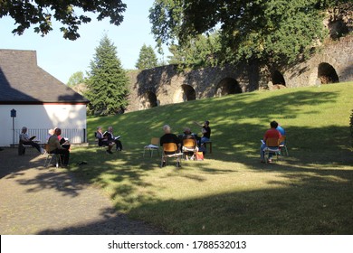 Blankenberg/NRW/Germany- July 29,2020 :  Group Of Church Choirs Practice Choir Singing Outside Church In Order To Keep Distance During COVID-19 Crisis.