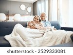 Blanket, coffee and mature couple on sofa in living room of home together for bonding, break or romance. Cozy, cuddle or hug with happy man and woman in apartment for love, relationship or drink