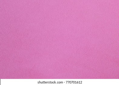 The blanket of furry pink fleece fabric. A background texture of light pink soft plush fleece material