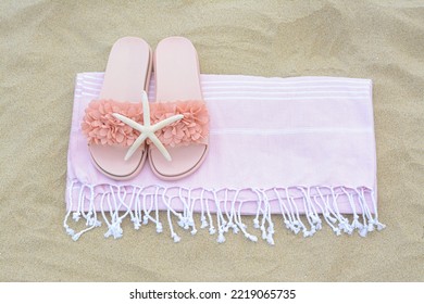 Blanket With Stylish Slippers And Starfish On Sand Outdoors, Top View. Beach Accessories