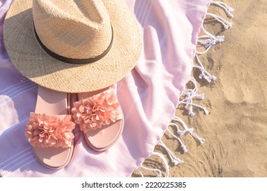 Blanket With Stylish Slippers And Straw Hat On Sandy Beach, Above View. Space For Text
