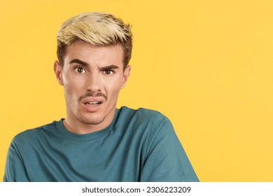 Blank-faced gay man stares at the camera - Shutterstock ID 2306223209