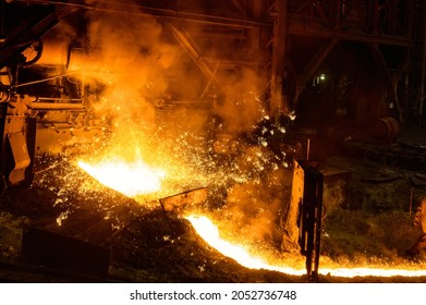 Blast furnace, cast iron production. Metal poured out of the metallurgical furnace - Shutterstock ID 2052736748