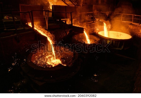Blast furnace slag and pig iron tapping.
Molten metal and slag are poured into a
ladle.