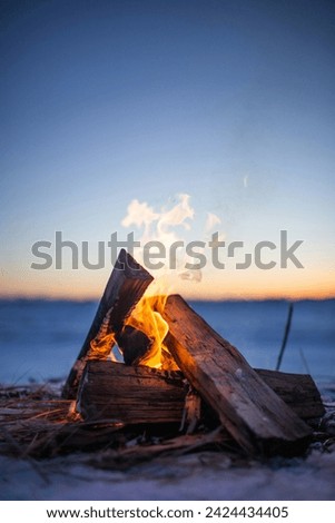 Blazing campfire at sunset along the beautiful beach of Lake Superior in northern Michigan...
