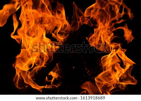 Blazing flames of a fire with black background