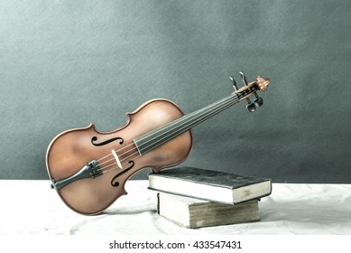 Bleach Bypass Color Of Violin Lay On Books, Still Life Of Violin