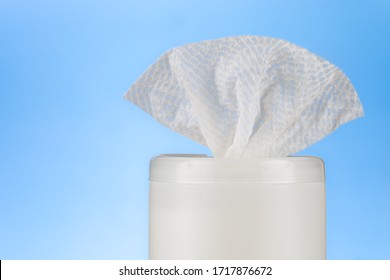 Bleach Disinfectant Wipes In Dispensing Container Against Blue Background. Sanitizing Antibacterial And Anti Germs Products For Household 