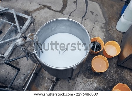 Bleach and dye acidic chemical compounds in an industrial metal stainless tell vat in chemical factory. Acid bath and virus contamination cleaning industry. Chemical plant factory processing.