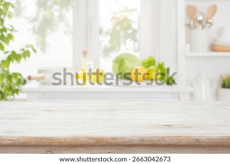 Bleached empty wooden table with bright interior of kitchen counter and window as blurred background. NO AI USED