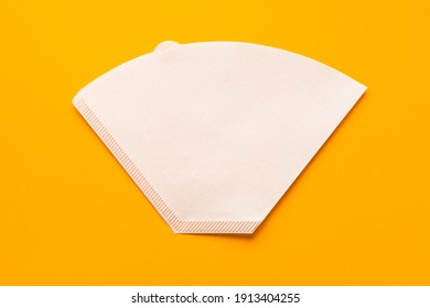 Bleached paper coffee filter for immersion brewing isolated on a colored yellow background. Alternative brewing v60 pour over method. Minimalistic abstract background - Shutterstock ID 1913404255