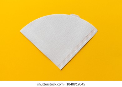 Bleached paper coffee filter isolated on a colored yellow background. Alternative brewing pour over coffee. Minimalistic abstract background - Shutterstock ID 1848919045