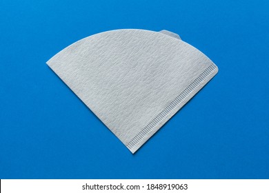 Bleached paper coffee filter isolated on a colored blue background. Alternative brewing pour over coffee. Minimalistic abstract background - Shutterstock ID 1848919063