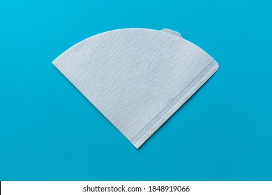 Bleached paper coffee filter isolated on a colored blue background. Alternative brewing pour over coffee. Minimalistic abstract background - Shutterstock ID 1848919066