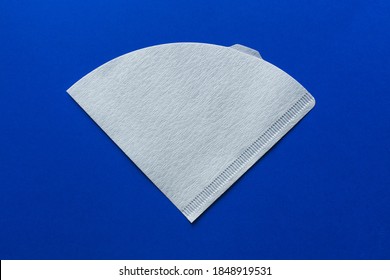 Bleached paper coffee filter isolated on a colored blue background. Alternative brewing pour over coffee. Minimalistic abstract background - Shutterstock ID 1848919531