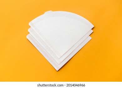 Bleached paper coffee filter isolated on yellow background. Alternative brewing pour over v60 concept. Minimalistic abstract background for store, shop, retail. mock up, top view, place for text - Shutterstock ID 2014046966