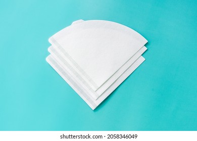 Bleached paper coffee filter isolated on light blue background. Alternative brewing pour over v60 concept. Minimalistic abstract background for store, shop, retail. mock up, top view, place for text - Shutterstock ID 2058346049