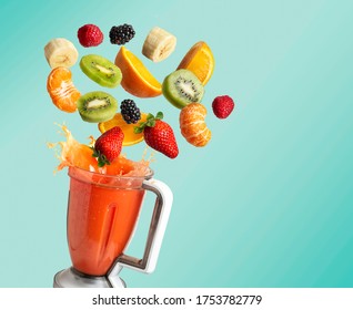 Blender and fruit flying  blue background and copy space  fruit juice   splash