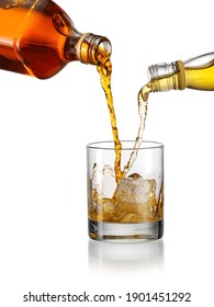 Blending Whiskey Concept, Pouring Two Kind Of Whiskey In A Glass With Ice Cubes