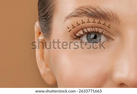 Blepharoplasty concept. Lady eye with arrows point in direction of planned oculoplastic surgery to tighten and lift the skin around her eyes, closeup cropped shot