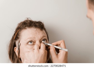 Blepharoplasty markup close-up on the face before the plastic surgery operation for modifying the eye region of the face in medical clinic - Shutterstock ID 2270028471