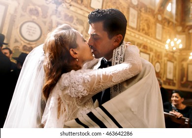 Blessed Kiss Of Jewish Wedding Couple Standing In The Synagogue