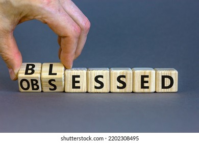 Blessed or obsessed symbol. Businessman turns wooden cubes and changes the concept word Obsessed to Blessed. Beautiful grey table grey background. Business blessed or obsessed concept. Copy space.