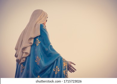 The blessed Virgin Mary statue figure in a sunset time. Catholic praying for our lady - The Virgin Mary.