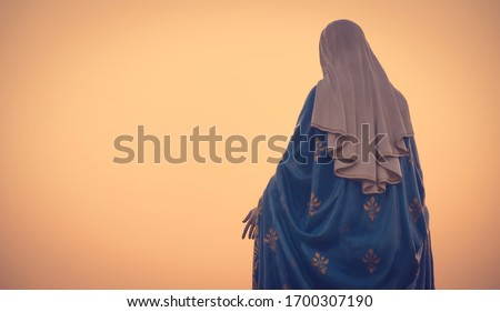 The blessed Virgin Mary statue figures in a warm tone - sunset scene. Catholic praying for our lady - The Virgin Mary. Faith and Trust in Christian Catholic.
