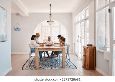 Blessing the meal thats to come. Shot of a family praying during lunch. - Powered by Shutterstock