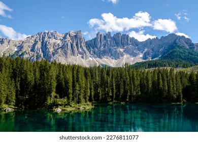 bleu lake in the dolomites Italy, Carezza lake Lago di Carezza, Karersee with Mount Latemar, Bolzano South Tyrol, Italy. The landscape of Lake Carezza or Karersee and the Dolomites in the background