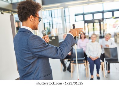 Blind business man as a speaker or life coach at a conference or congress