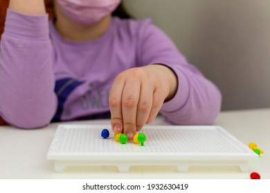 A Blind Child Develops Fine Motor Skills. Picking Up The Plastic Mosaic. Hands Of A Child Close-up. Development Through The Game.