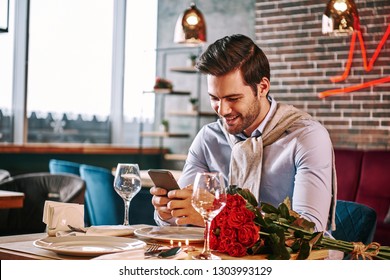 Blind Date. Man Is Chatting While Waiting In Restaurant