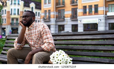 Blind Date, Nervous Young Man Waiting For Girl, Sitting Park Bench With Flowers