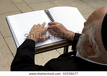 Blind israelite being prayed in the wailing wall according to Braille's book.