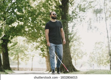 Blind Man. People With Disability, Handicapped Person And Everyday Life. Visually Impaired Man With Walking Stick, Descending Steps In City Park.