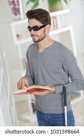 Blind Man Reading At Home