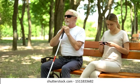 Blind Man Sitting On Bench, Healthy Lady Using Phone Instead Enjoying Nature